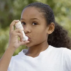 Young girl using an inhaler