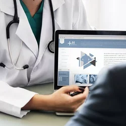 Doctor showing patient a patient portal website on laptop